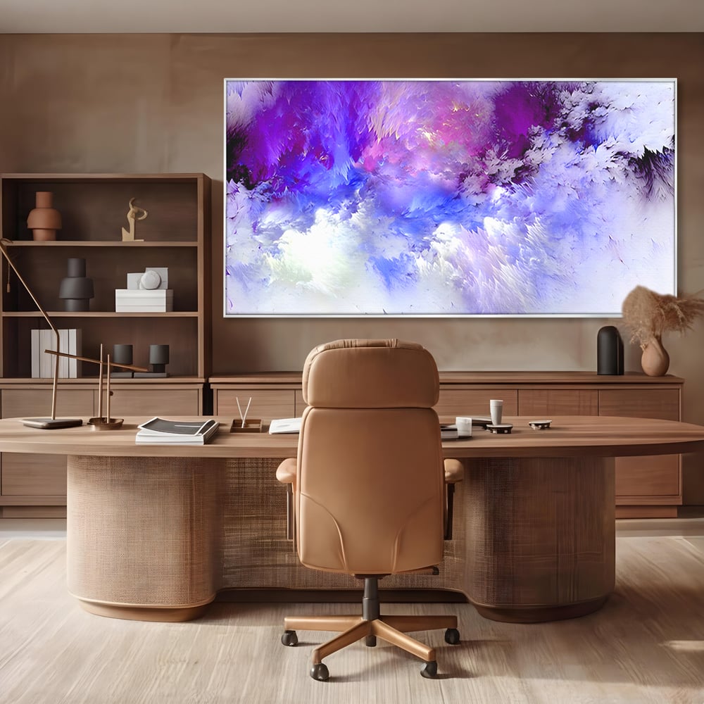 Tablou canvas cu pictura abstracta cu nori mov si albastri, in rama de aluminiu argintiu, pe perete intr-un birou
